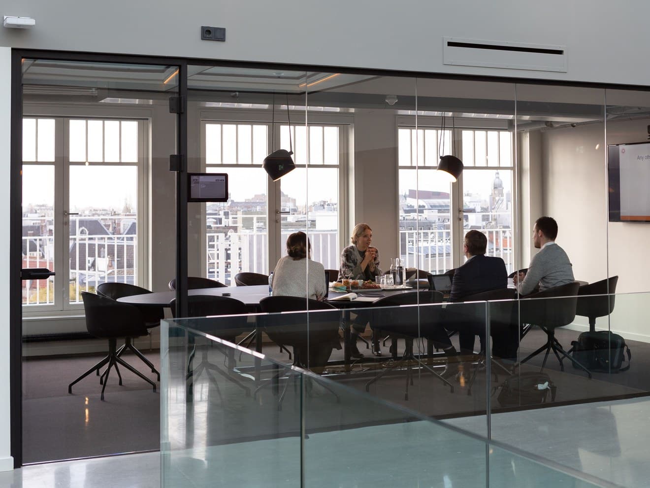 A Melsoft project team in session in a glass-walled meeting room